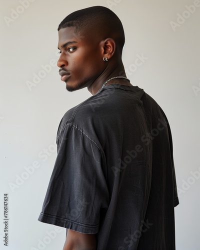 Young african american man posing in black t-shirt from back on white background, mock up