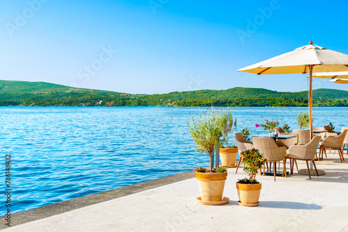 Mediterranean cafe on the shore of the Bay of Kotor - Boka Bay, with beautiful view to the coastline, Montenegro