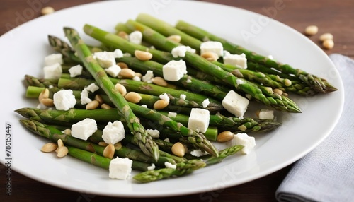 Warm salad with asparagus, feta cheese, pine nuts and lemon
