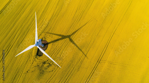 Aerial view of wind turbine on yellow field