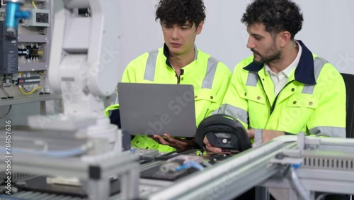 Group of multiethnic engineer researching and developing a robotics arm in scientific technology laboratory. Technician examining Industrial robot machine. Automated and manufacturing factory concepts