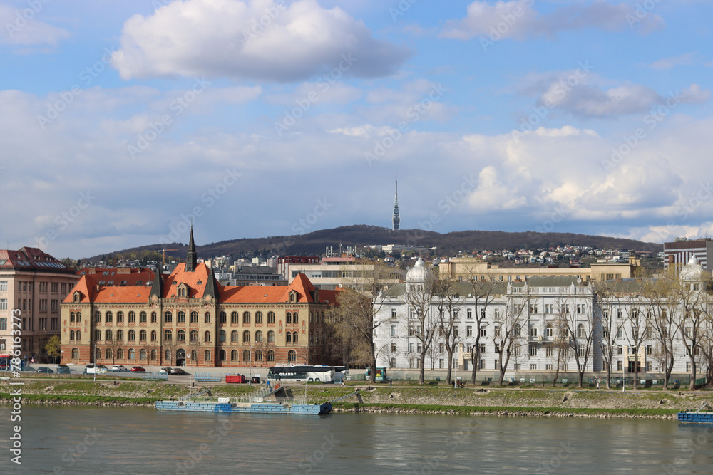 Architecture of Bratislava, Slovakia. View on old town from Danube river. Cloudy spring day. Panoramic photo of beautiful old buildings. Tourist destinations concept. 