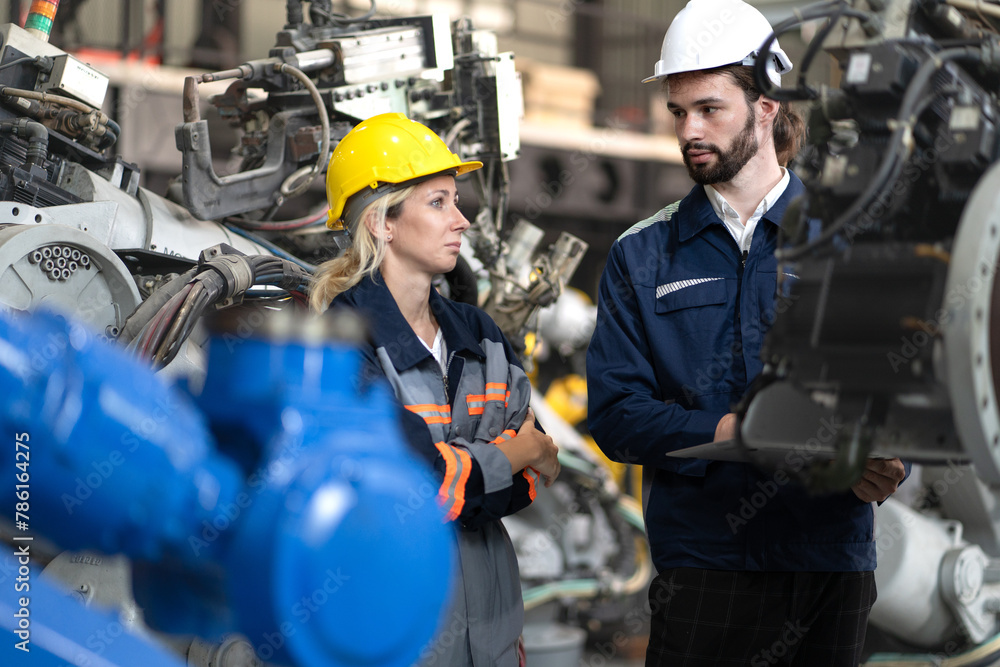 Robotic engineer team standing together meeting at factory discussing electronic robot machine engineering. AI high tech production technician teamwork working at futuristic technology manufacturing Robotic engineer team standing together meeting at factory discussing electronic robot machine engineering. AI high tech production technician teamwork working at futuristic technology manufacturing