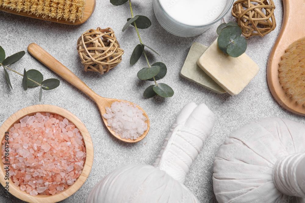 Flat lay composition with spa products and eucalyptus branches on light grey table Flat lay composition with spa products and eucalyptus branches on light grey table