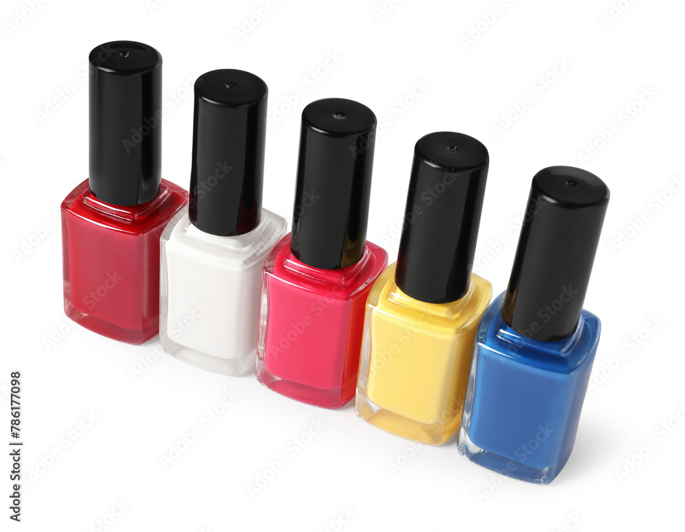 Bright nail polishes in bottles isolated on white Bright nail polishes in bottles isolated on white