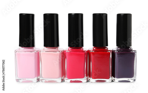 Bright nail polishes in bottles isolated on white