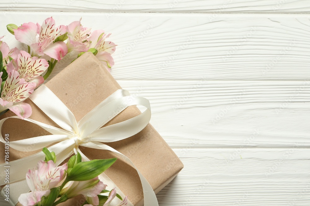 Happy Mother's Day. Beautiful flowers and gift box on white wooden table, flat lay. Space for text Happy Mother's Day. Beautiful flowers and gift box on white wooden table, flat lay. Space for text