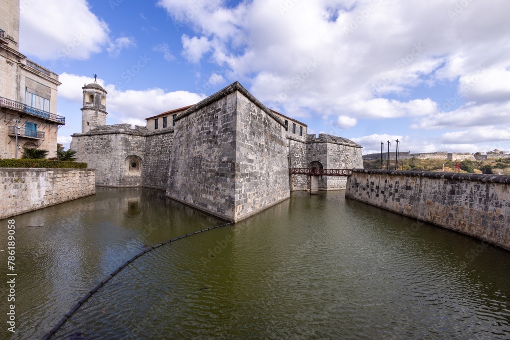 An old historic building in the city of Havana in Cuba showing the castle surrounded by a moat An old historic building in the city of Havana in Cuba showing the castle surrounded by a moat