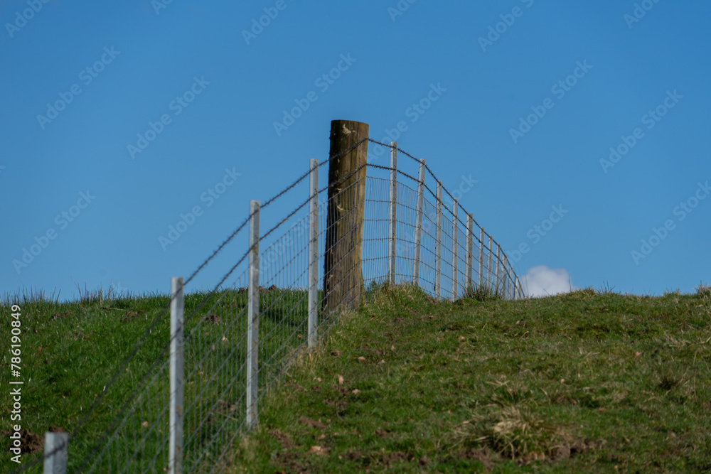 Wire fence on the brow of a hill Wire fence on the brow of a hill