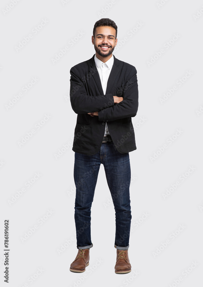 Full length studio portrait of handsome smiling young man with folded arms isolated on gray background Full length studio portrait of handsome smiling young man with folded arms isolated on gray background