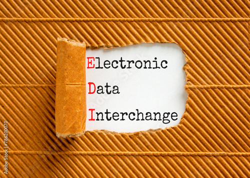 EDI electronic data interchange symbol. Concept words EDI electronic data interchange on white paper on a beautiful brown background. Business and EDI electronic data interchange concept. Copy space. photo