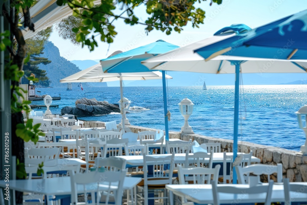 Obraz premium Seaside Summer Cafe With Blue and White Umbrellas