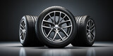 A stack of new car wheels with aluminum rims on a black background Group of new car tires 