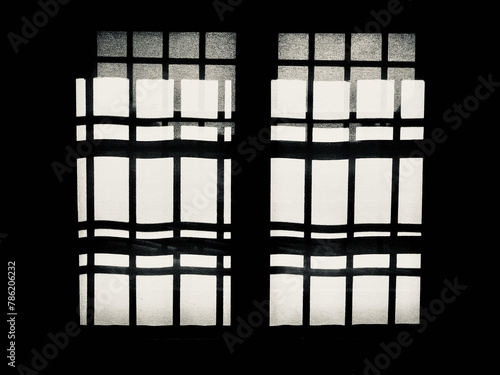 window with iron grates seen against the light