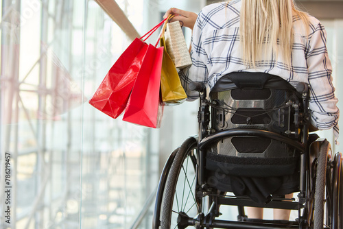 Independent shopping experience of a young woman using a wheelchair at a modern mall photo