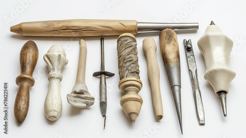 Assorted pottery and sculpting tools with various wooden and metal handles on a white background. photo