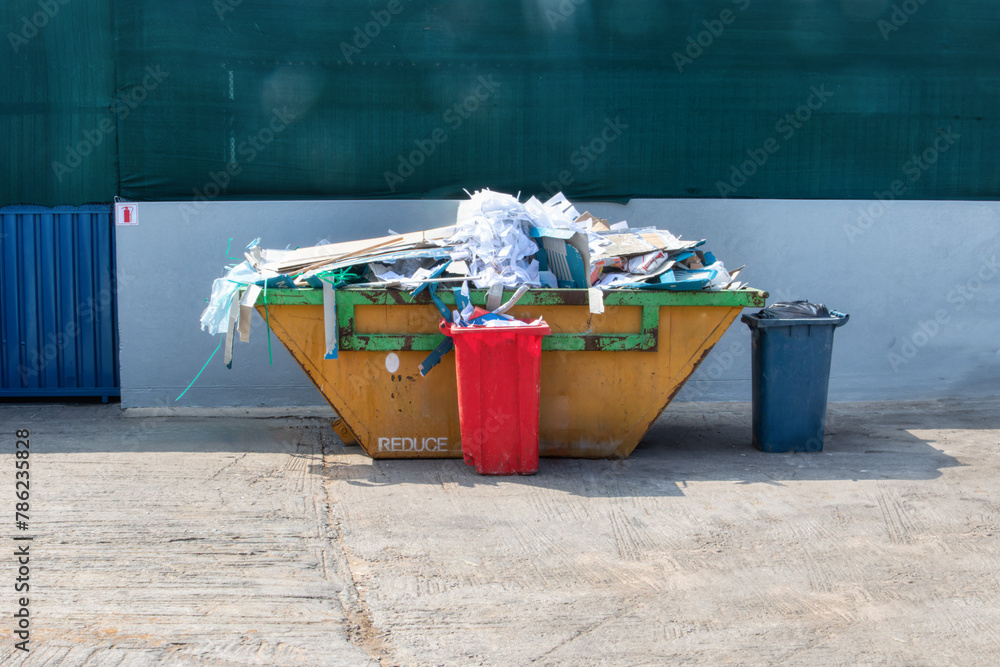  recycle paper separation in the metal bin outdoors in front of the warehouse - obrazy, fototapety, plakaty 