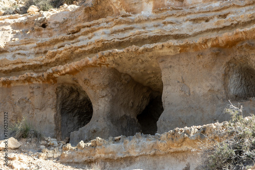 Natural walk next to the júcar river, popular cave houses, carved into the mountain,  region of La Manchuela, in Alcalá del Júcar (Albacete, Spain). photo