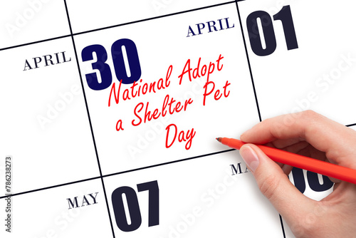 April 30. Hand writing text National Adopt a Shelter Pet Day on calendar date. Save the date. © Alena