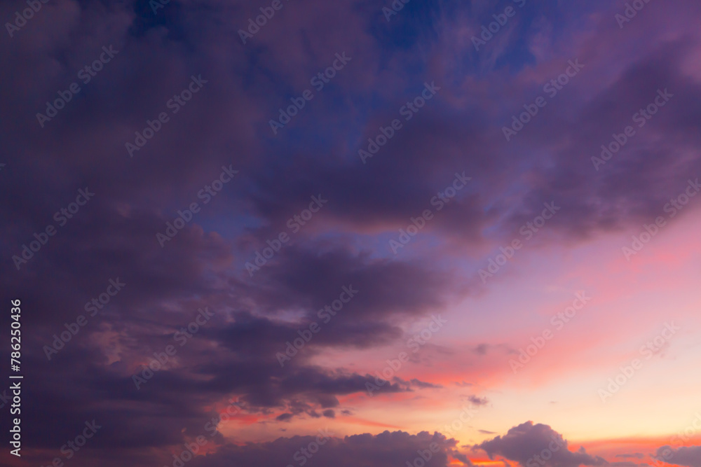 Clouds and orange sky,Real majestic sunrise sunset sky background with gentle colorful clouds without birds.Panorama, large