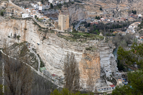 Panoramic view of the town of Alcalá del júcar from Casas del Cerro. Its popular cave houses, carved into the mountain, the castle and Church of San Andrés in the gorge of the júcar rive, Albacete.