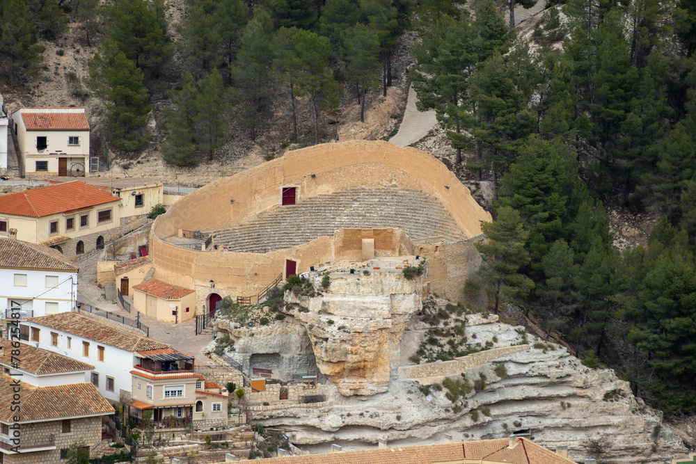 Panoramic view of the Alcalá del júcar Bullring  from Casas del Cerro. Its popular cave houses, carved into the mountain, the castle and Church of San Andrés in the gorge of the júcar rive, Albacete.
