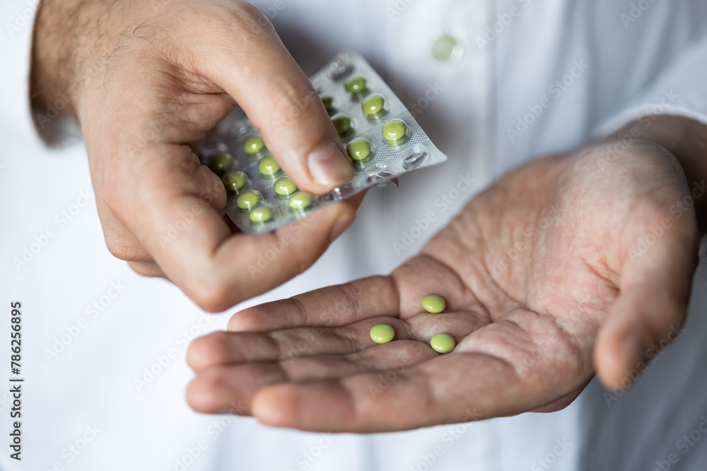 sick-man-takes-pills-blister-pack-palm-hand-homeopathy-treatment-of