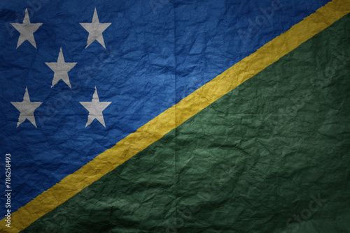 big national flag of Solomon Islands on a grunge old paper texture background