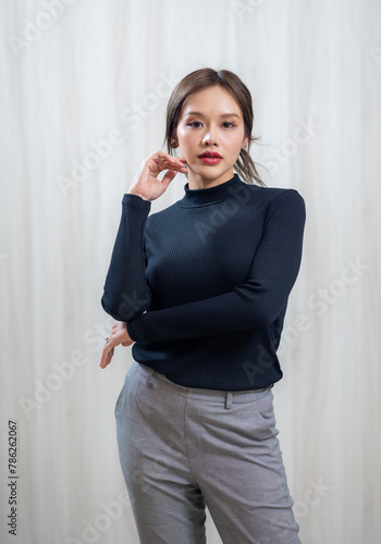 Portrait People lifestyle concept - sexy femal.  Asian woman in white and green winter knitted sweater shirt standing wood wall background
