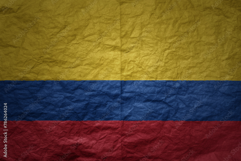 big national flag of colombia on a grunge old paper texture background