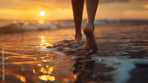 Barefoot walk on the beach at sunset. Concept of travel and vacation
