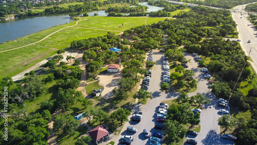 90-acre Brushy Creek Lake Park lush greenery area with busy car parking, sand volleyball courts, scenic picnic pavilion areas, 20 miles north of downtown Austin in Cedar Park, Williamson county aerial photo