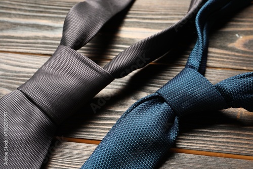Two neckties on wooden table, closeup view
