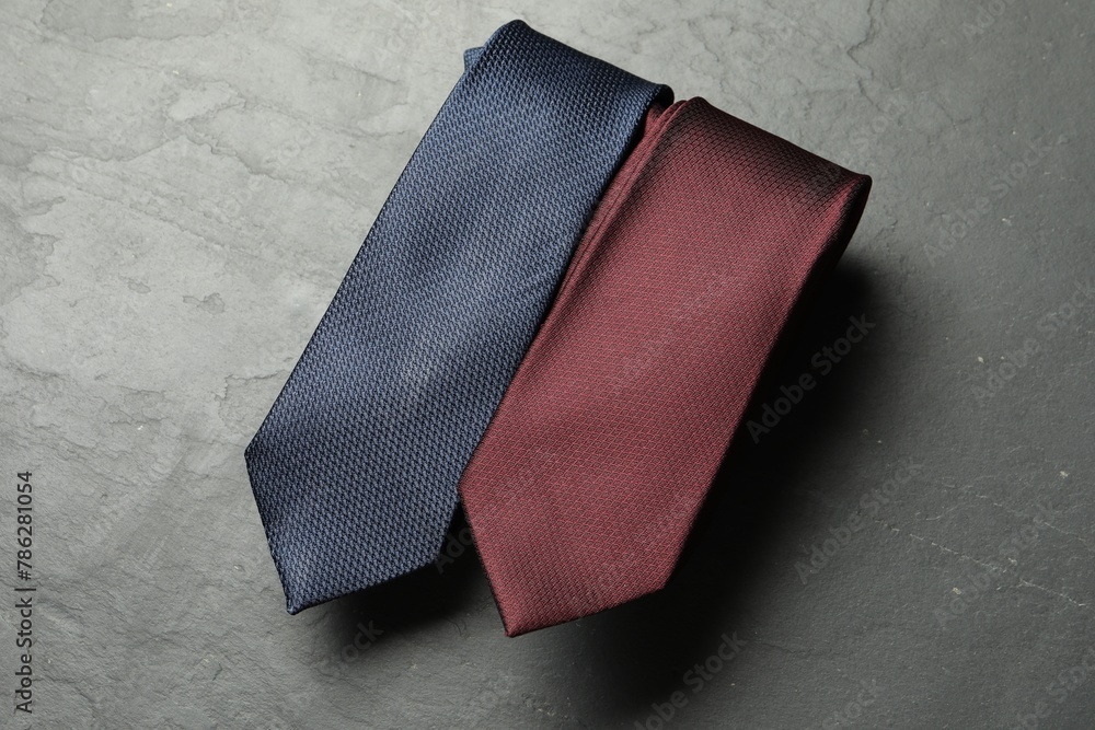 Two neckties on grey textured table, top view Two neckties on grey textured table, top view