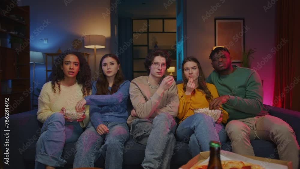 People gathering on couch for observing horror movie