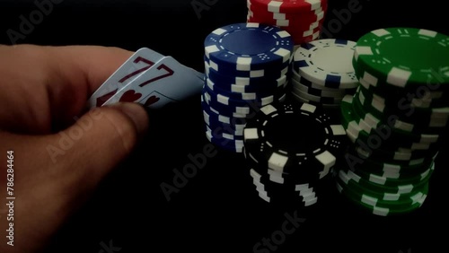 Poker chips and cards in a casino on a black background