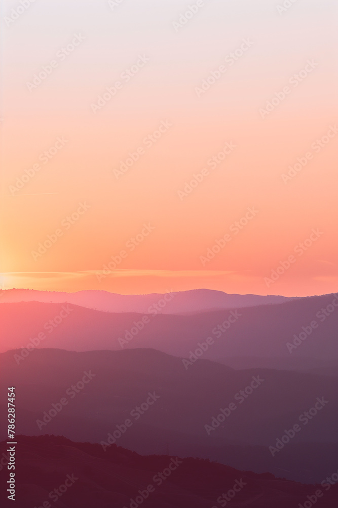 Vibrant Sunrise Over Mountains. Warm-toned sunrise over a tranquil mountain range, ideal for travel or nature themes.