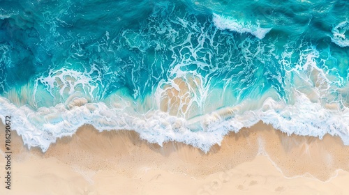 Aerial view of liquid waves crashing on sandy beach