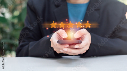Reward and Satisfaction Concept. Businessman showing and giving five stars on hand. Business Quality Assessment, ISO, Quality Assurance, Certification.