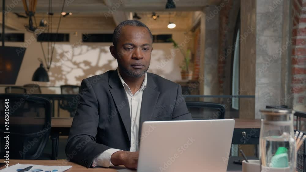 African American middle-aged entrepreneur typing laptop computer ethnic happy smiling business man office businessman male guy working with pc online job work at table smiling toothy healthy at camera African American middle-aged entrepreneur typing laptop computer ethnic happy smiling business man office businessman male guy working with pc online job work at table smiling toothy healthy at camera