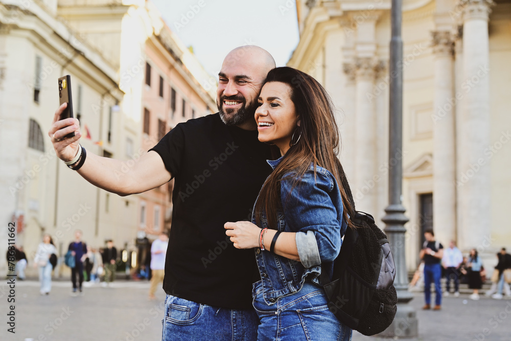 Happy  Beautiful Tourists  couple traveling at Rome, Italy, taking a selfie portrait Visiting Italy - man and woman enjoying weekend vacation - Happy lifestyle concept 