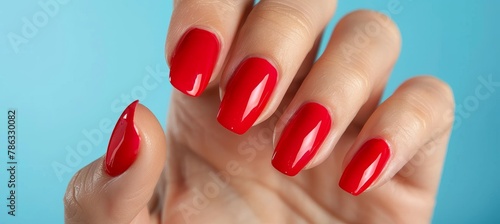 Close up of elegant woman s hand with stylish red nail polish on perfectly manicured fingernails