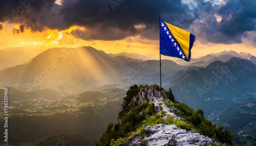 The Flag of Bosnia and Herzegovina On The Mountain. photo