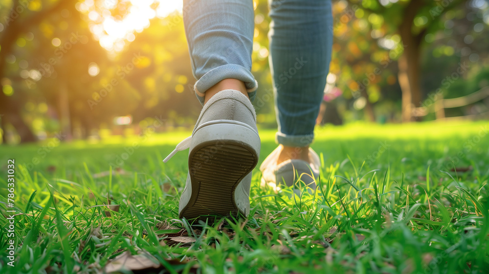 Woman Walking Outdoors in the Park: Close-up on Shoe with Rolled Up Jeans, Taking a Step. Embracing the Concept of New Beginnings and Fresh Starts.