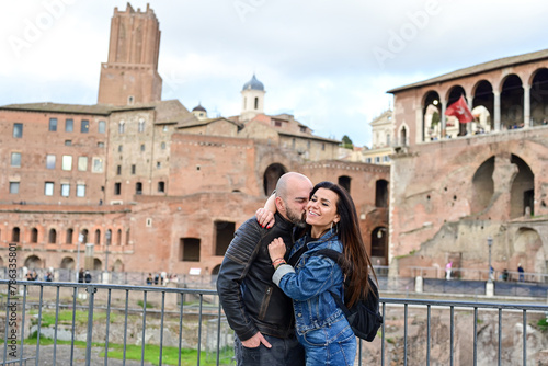 Happy  Beautiful Tourists  couple traveling at Rome, Italy, poses in front of   Rpman Forum   at, Rome, Italy