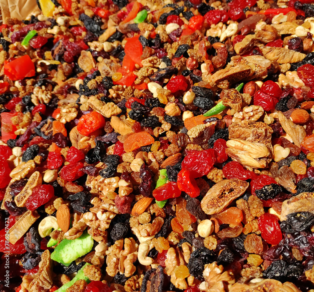 A mixture of colorful dried walnuts, cashews, hazelnuts and fruits, cherries, grapes, figs and kiwi A mixture of colorful dried walnuts, cashews, hazelnuts and fruits, cherries, grapes, figs and kiwi