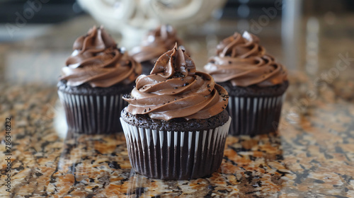 Dark chocolate cupcakes with chocolate ganache frosting photo