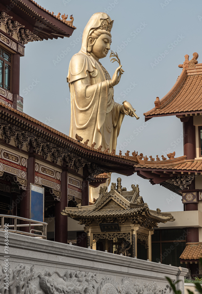 Big Golden statue goddess of Mercy Guanyin or Quan Yin statue at Fo Guang Shan Thaihua Temple. Guan Yin Buddha, Taiwanese temple style, Space for text, Selective focus.