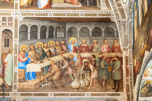 Detail of colorful religious fresco on church wall in Italy showing a version of the last supper