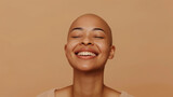 A bald woman with a shaved head after chemotherapy. Beautiful Young women standing isolated over beige background. Concept of supporting to all women suffering from cancer